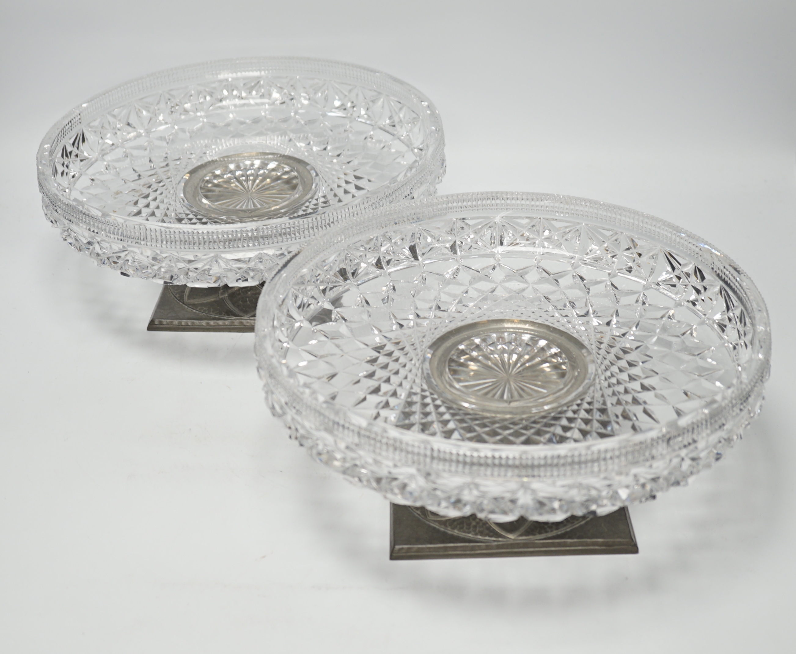 A pair of Tudric pewter based tazza with cut glass bowls, bowls 28cm diameter